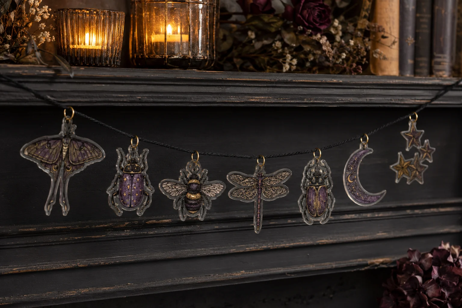 Finished celestial insect shrink-plastic charm garland with translucent moth, beetle, bee, dragonfly, scarab, moon, and star pieces hanging from black cord